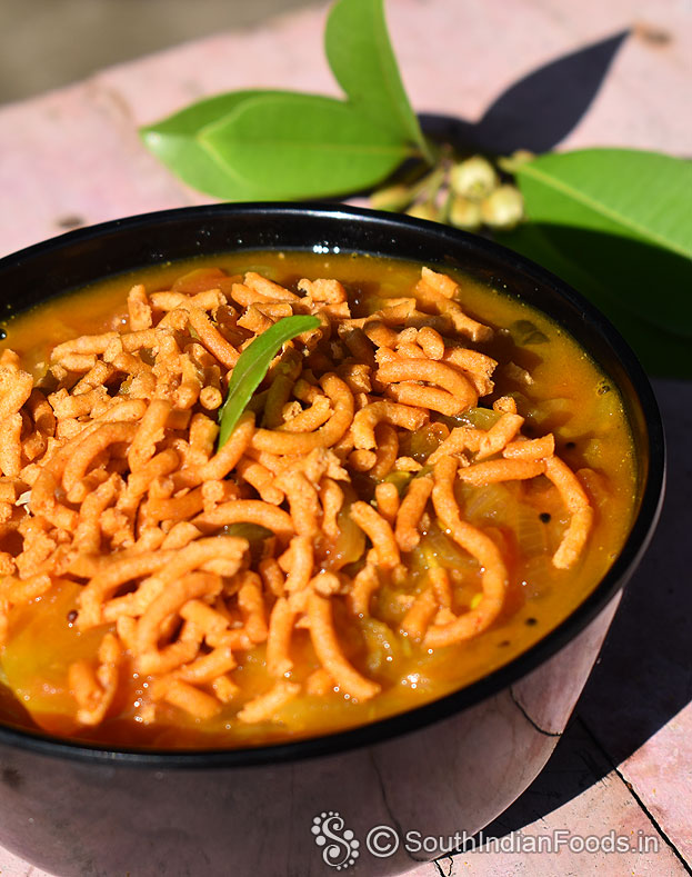 Tamatar sev curry, serve hot with rice / chapathi