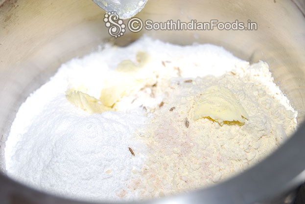 Take a bowl add rice flour, roasted gram flour, butter, cumin seeds, asafetida & salt mix well.