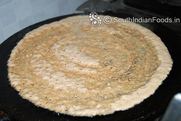 Heat iron dosa tawa pour batter, evenly spread, sprinkle oil , & cook till crisp on both sides